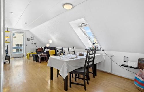 a dining room and living room with a table and chairs at Nice Home In Mariager With Wifi in Mariager