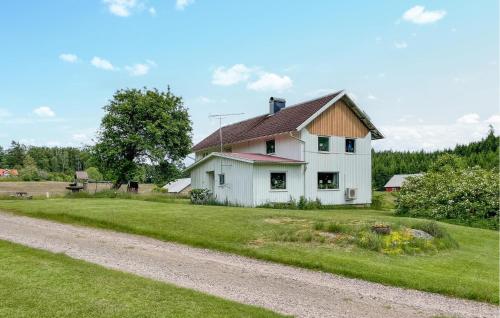 a white house on the side of a dirt road at Gorgeous Home In Östra Frölunda in Östra Frölunda