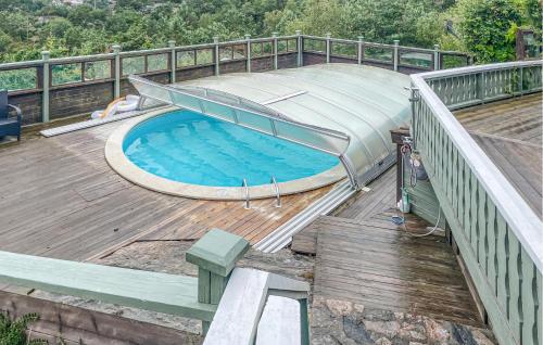 a large swimming pool on a deck with a slide at 5 Bedroom Cozy Home In Mandal in Mandal