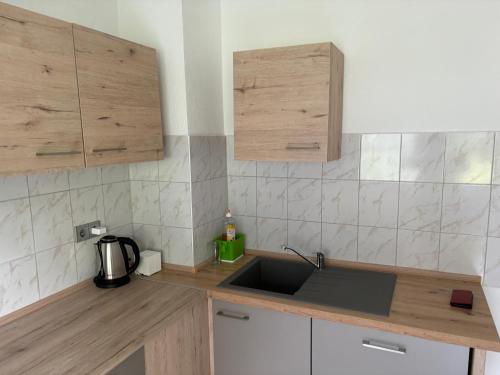 a kitchen with a sink and wooden counter top at Ferienwohnung Grimm 3 in Pforzheim