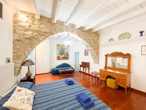 a bedroom with a bed in a room with a stone wall at Kalavasos Square Apartments - With Access to Shared Pool 3 Minutes Walk in Kalavasos