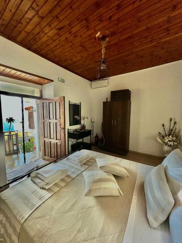 a large white bed with pillows in a bedroom at Artemis Traditional House in Kerames