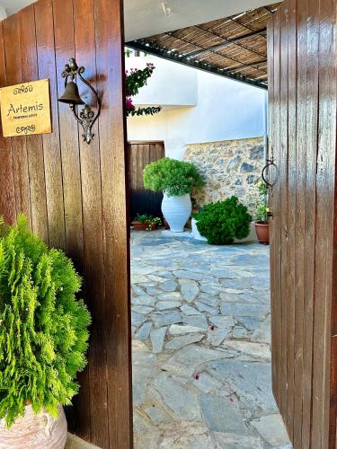 a entrance to a patio with plants and a sign at Artemis Traditional House in Kerames