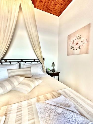 a bedroom with a large bed with a wooden ceiling at Artemis Traditional House in Kerames