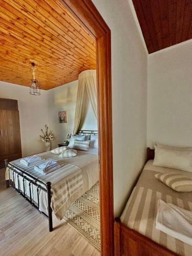 a bedroom with a bed and a large doorway at Artemis Traditional House in Kerames