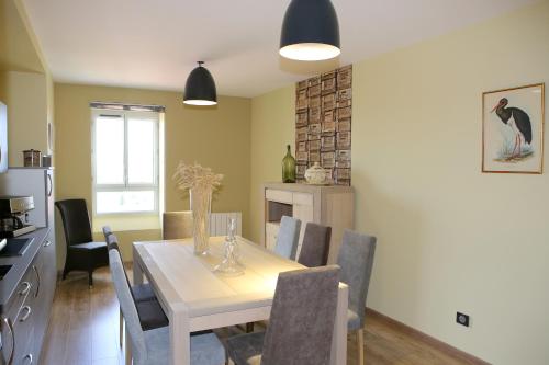 a kitchen and dining room with a table and chairs at Aux Pierres Magiques in Saint-Laurent-de-Chamousset