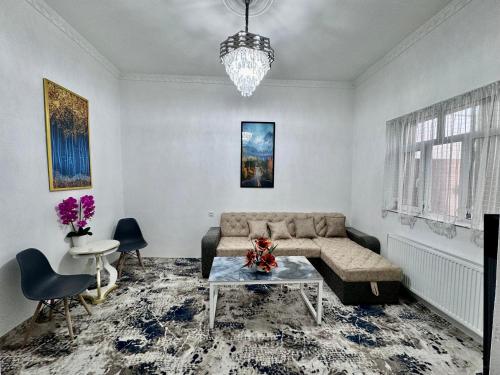 a living room with a couch and a table at Komolon in Tashkent