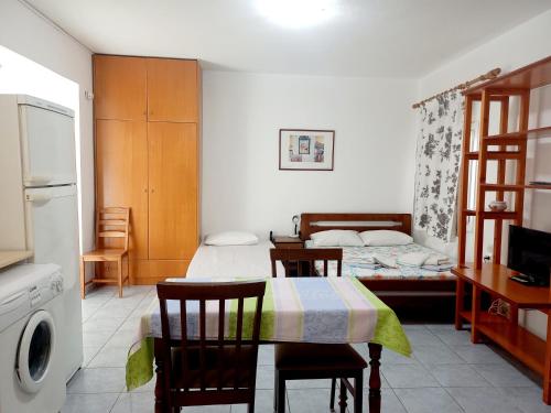 a bedroom with a bed and a table and chairs at Apartment Kasper in Skiathos Town