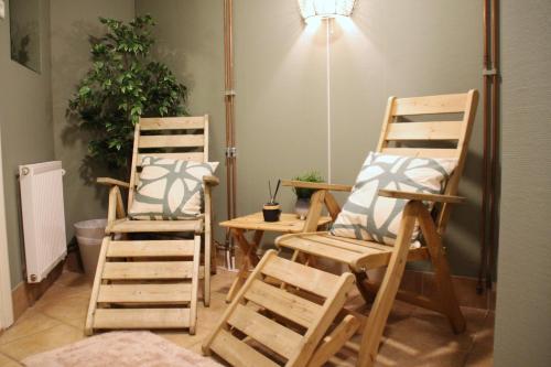 two wooden chairs and a table in a room at Rödlix Vandrarhem & Camping in Tvååker