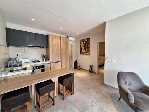 a kitchen with a large wooden table and chairs at Forest View Apartments in Kololi