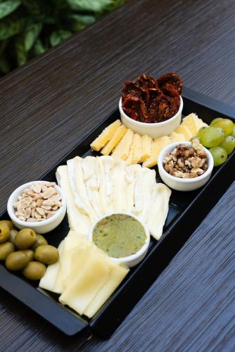 a tray of cheese and other foods on a table at Blank Hotel Recoleta in Buenos Aires