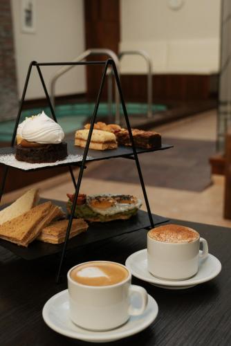 a tray with two cups of coffee and cookies at Blank Hotel Recoleta in Buenos Aires