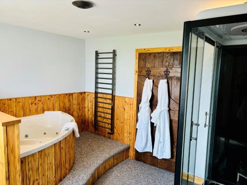 a bathroom with a bath tub and a ladder at Sneaton Castle in Whitby