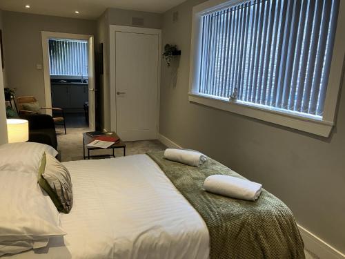 a bedroom with a bed with two pillows on it at Teviot View in Hawick