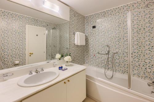 a bathroom with a sink and a shower at Hotel Barchetta Excelsior in Como
