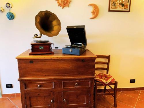 a wooden dresser with a mirror on top of it at Casa la Buriana in Vinci