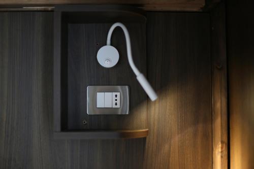 a lightswitch with a mouse on a wooden wall at AuRoom in Naples