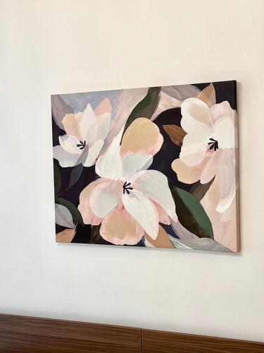 a painting of white flowers on a wall at Grandmas holiday home Sicily in Giarre