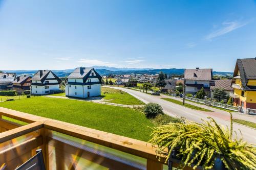 a view of a town from the balcony of a house at Czorsztyn- Kluszkowce Lake & Ski in Kluszkowce