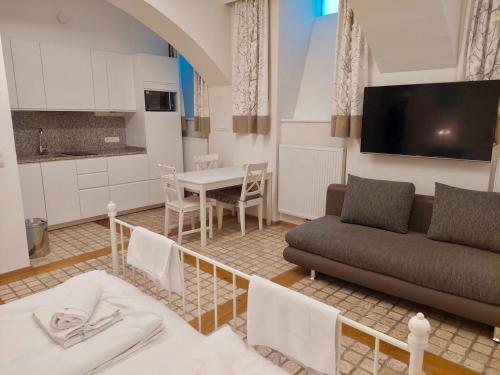 a living room with a couch and a table at Modern Studios near City Center in Vienna