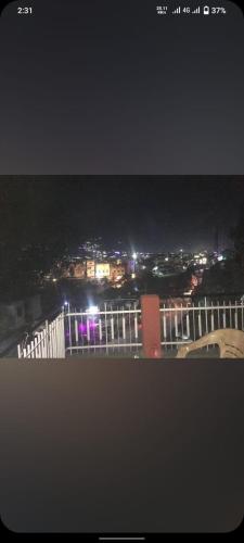 a view of a city at night with lights at Hotel NainKaran Tourist Lodge And Restaurant in Uttarkāshi
