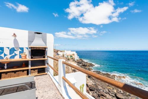 a balcony with a view of the ocean at Luminous loft apartment next to the Atlantic Ocean in Radazul