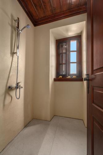 an empty room with a shower and a window at Telegraphus Boutique Home in Skiathos