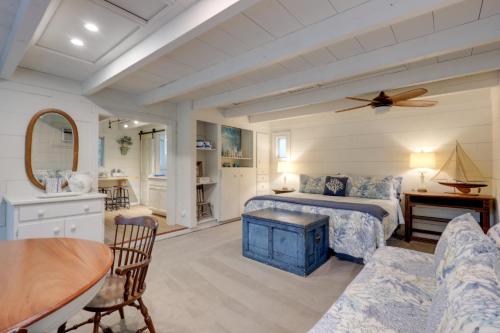 a bedroom with a bed and a living room at Nantucket Cottage with Fishing Dock and Sunsets in Fernandina Beach
