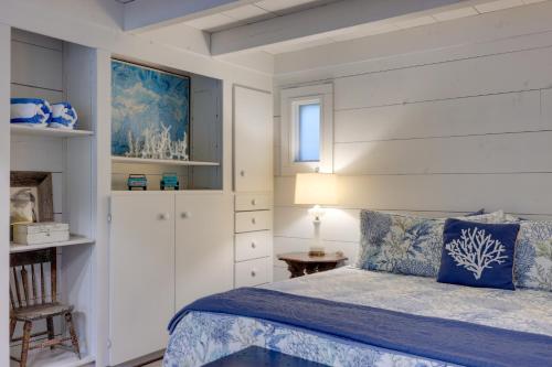 a bedroom with a bed and a table and a chair at Nantucket Cottage with Fishing Dock and Sunsets in Fernandina Beach