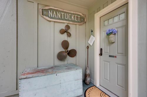 a porch with a door and a sign on the wall at Nantucket Cottage with Fishing Dock and Sunsets in Fernandina Beach