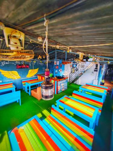 a room with colorful tables and benches in it at Lucky Restaurant & Guest House in Agra