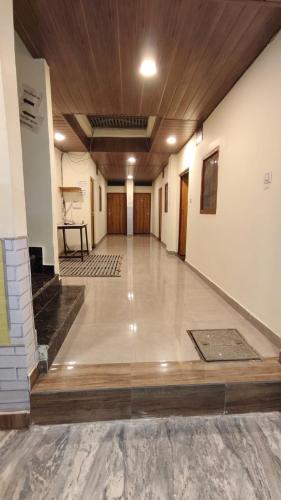 a large empty room with a wooden ceiling at Sunrise Homestay Agra Near Taj Mahal in Agra