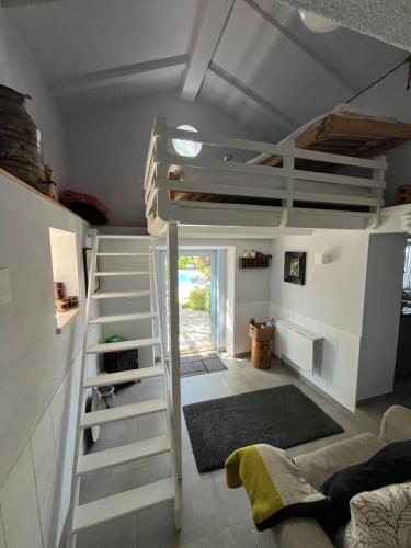 a room with a loft bed and a couch at Casa Oliva-Casa da Eira in Porto de Mós
