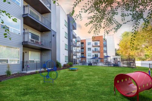 a yard with a playground in front of a building at Serene Space with Easy City Access in Salt Lake City