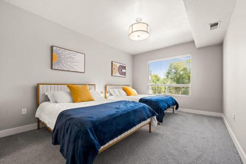 two beds in a bedroom with a window at Cozy Getaway Near City Center in Salt Lake City