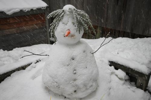 a snowman is standing in the snow at CHILL-OUT - Thredbo in Thredbo