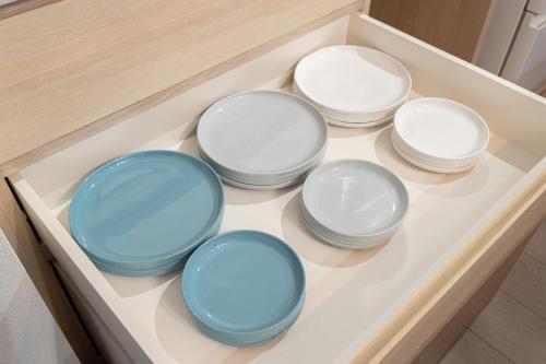 a group of bowls sitting in a drawer at Mova Villa Okino in Kikuyo