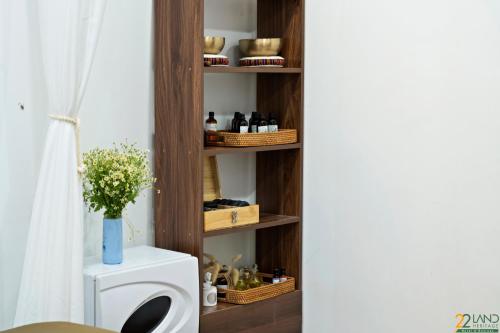 a room with a shelf with bottles and baskets at 22Land Classic Suites in Hanoi