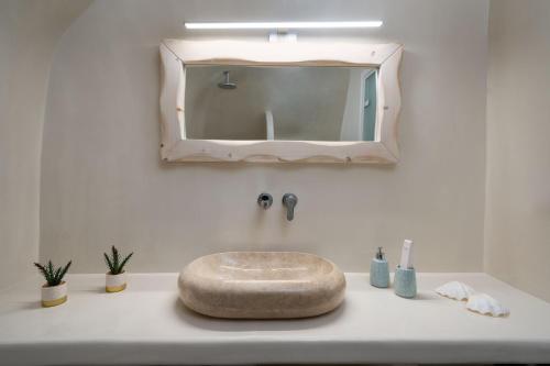 a bathroom sink with a large mirror above it at NEW Yiota Collection 4 Suites & 4 Prive Jacuzzi in Megalokhori
