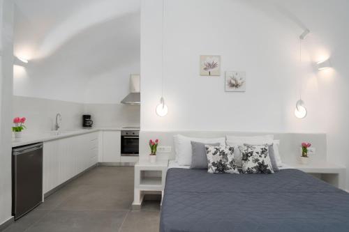a bedroom with a bed and a kitchen at NEW Yiota Collection 4 Suites & 4 Prive Jacuzzi in Megalokhori