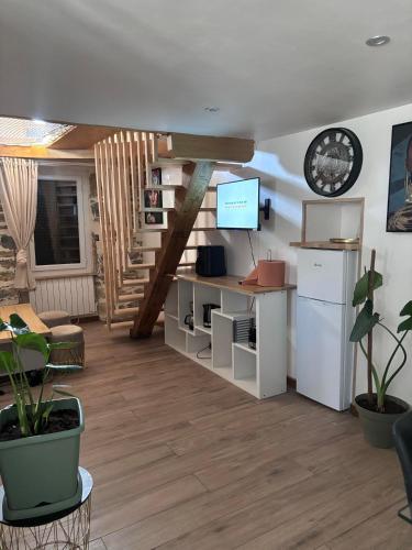 un salon avec un escalier et une télévision dans l'établissement T1 Duplex avec filet detente, à Millau