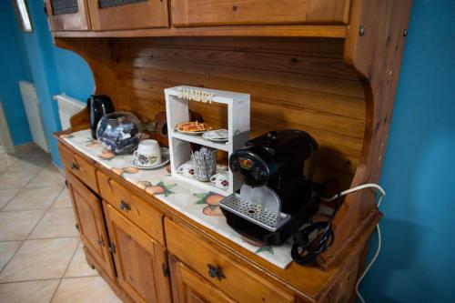 a wooden cabinet with a telephone and other items on it at Dimora Del Cilento in Roccadaspide