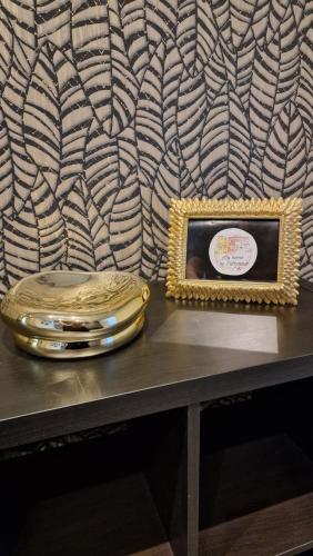 a mirror and a plate on a table with a picture at My home in Sarzana in Sarzana