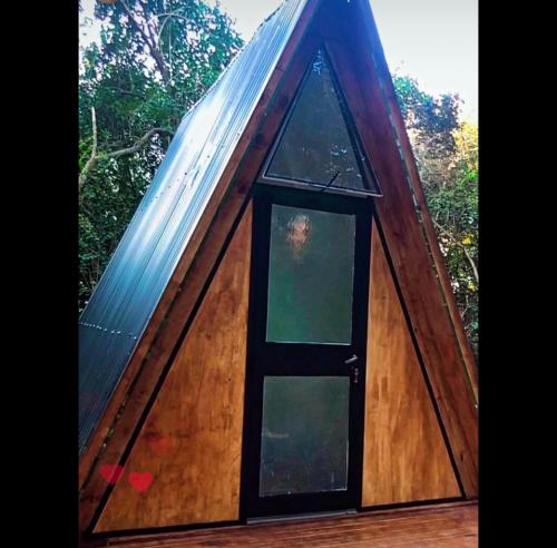 a small house with a window and a roof at Forest Glam in San Andrés de Giles