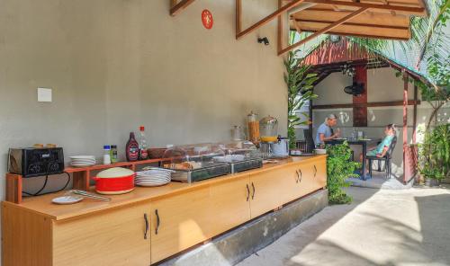 a kitchen with a counter with food on it at Ganduvaru Villa in Ukulhas