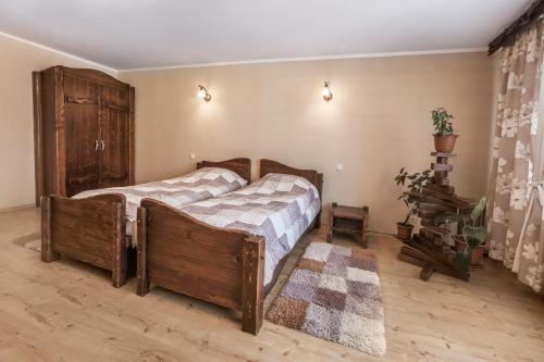 a bedroom with a large wooden bed in a room at Aquadar in Manʼkivka