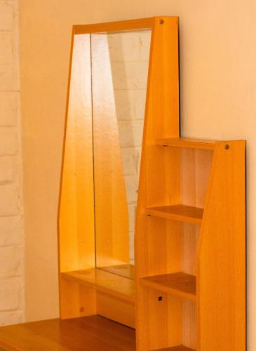 a mirror sitting on top of a wooden shelf at LUSHOTO EXECUTIVE LODGE in Lushoto