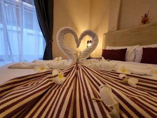 two swans making a heart on a bed at Rest Hub Poolvilla in Jomtien Beach