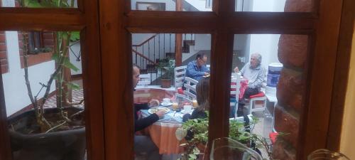 a group of people sitting around a table at Hotel Casa Ecuatreasures Centro Historico in Quito
