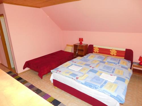 a small bedroom with a bed and a night stand at Apartmany Tania in Závažná Poruba